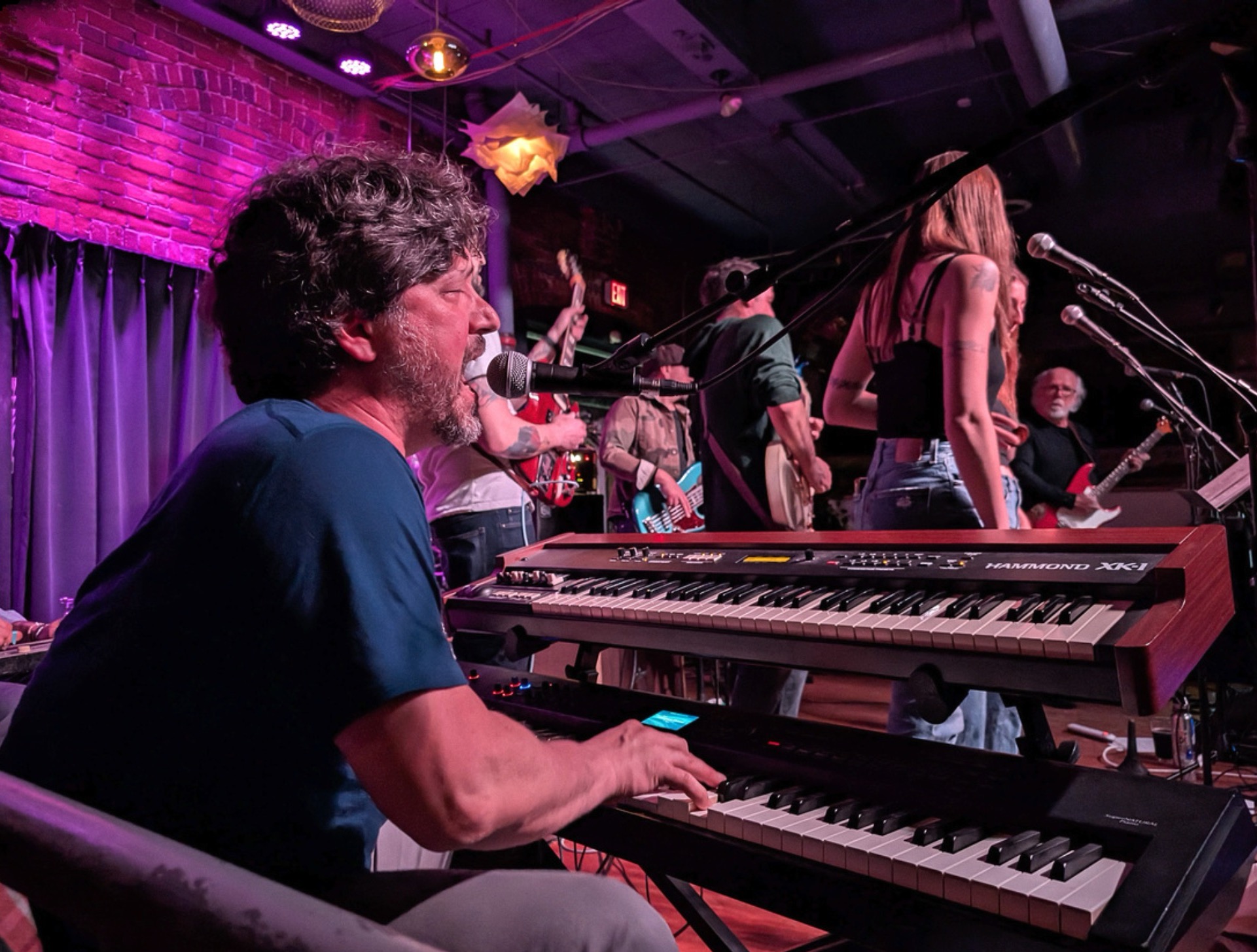 Keyboardist singing at the Hammond XK-1