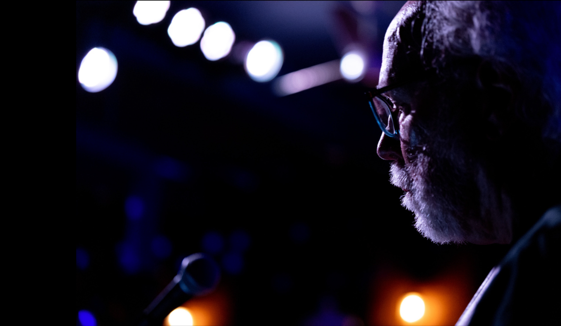Jim Murphy in profile under the stage lights
