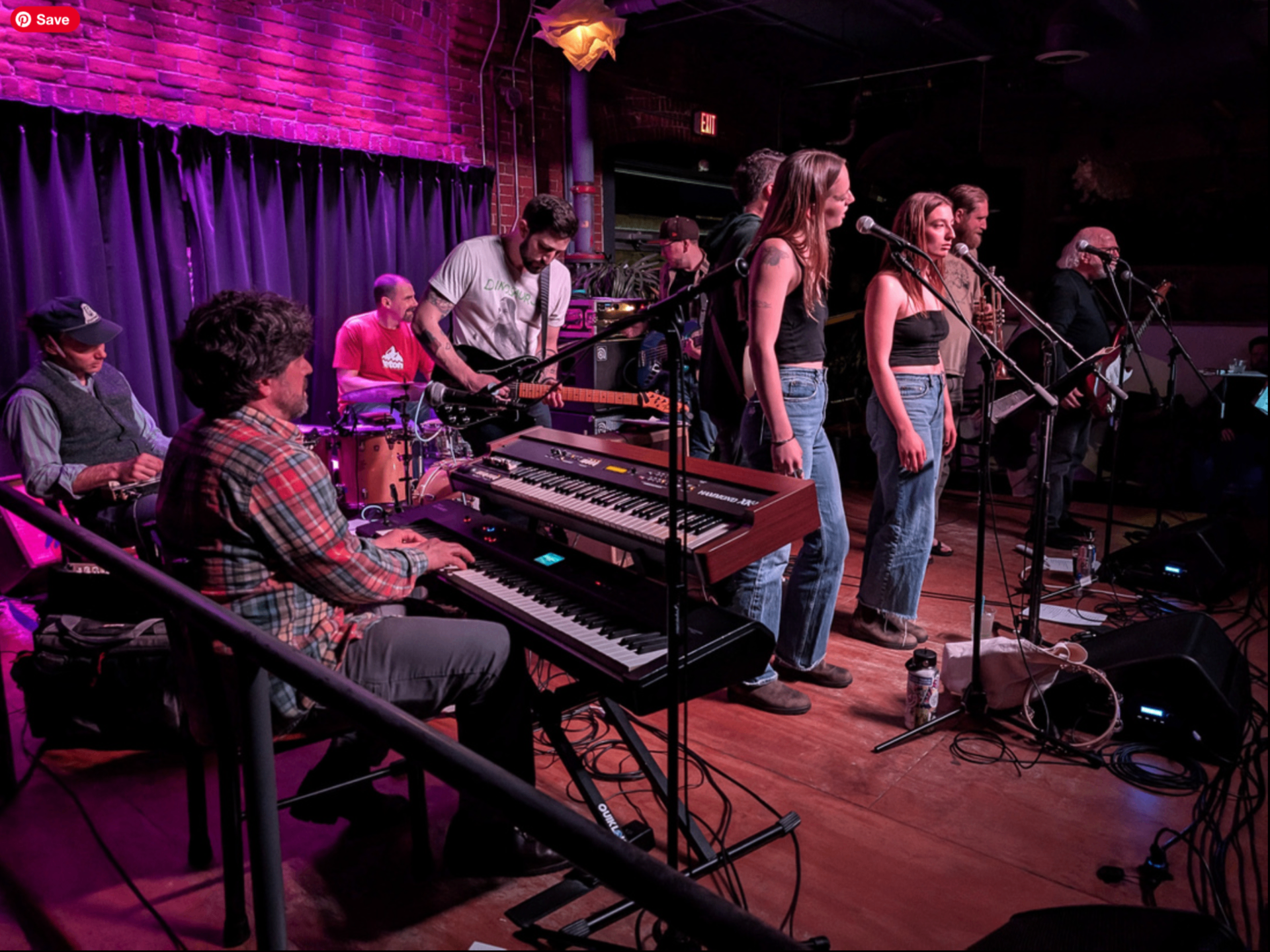 Full band on stage with horns and vocalists